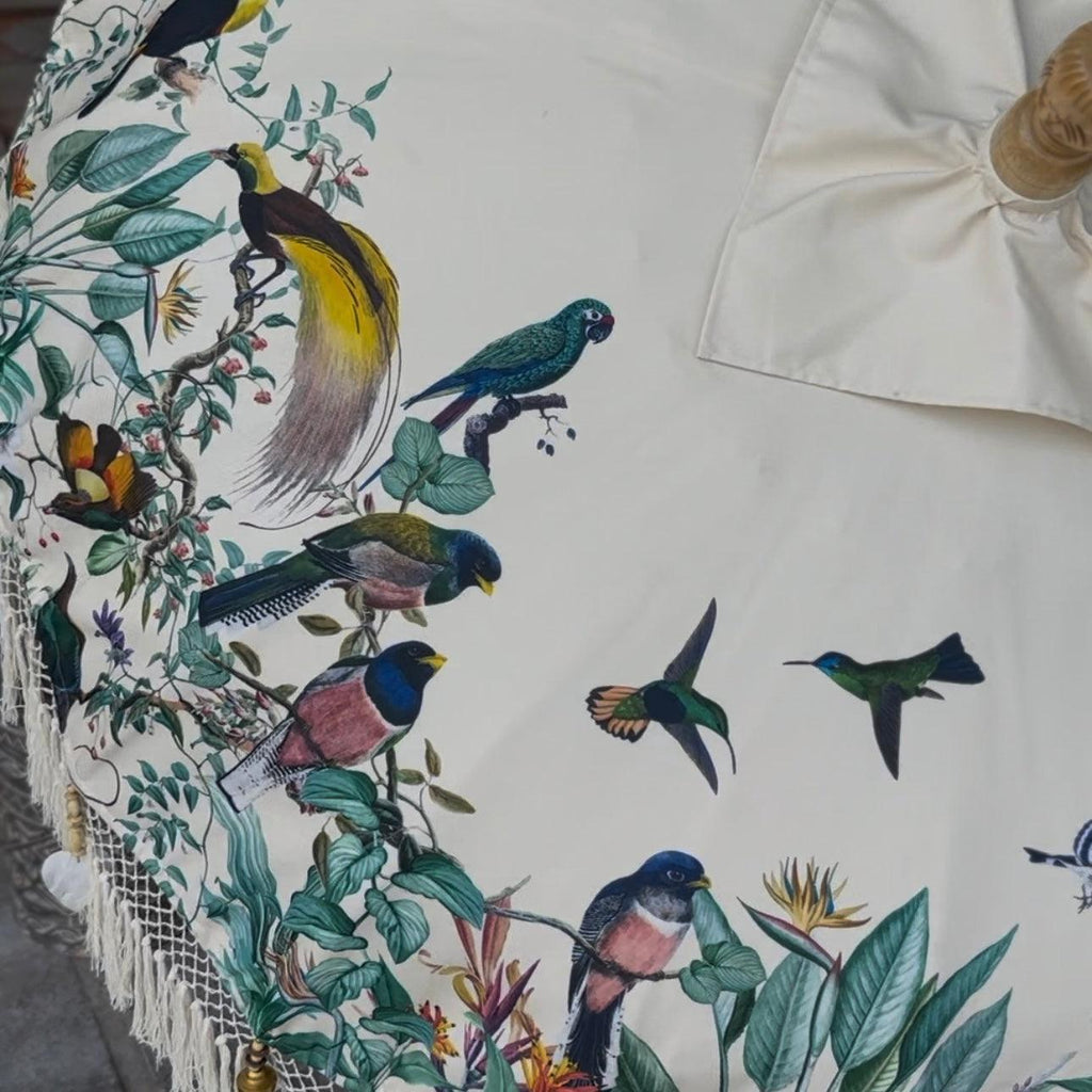 Detailed view of exotic birds and lush greenery on the Birdie Parasol, combining nature and elegance.