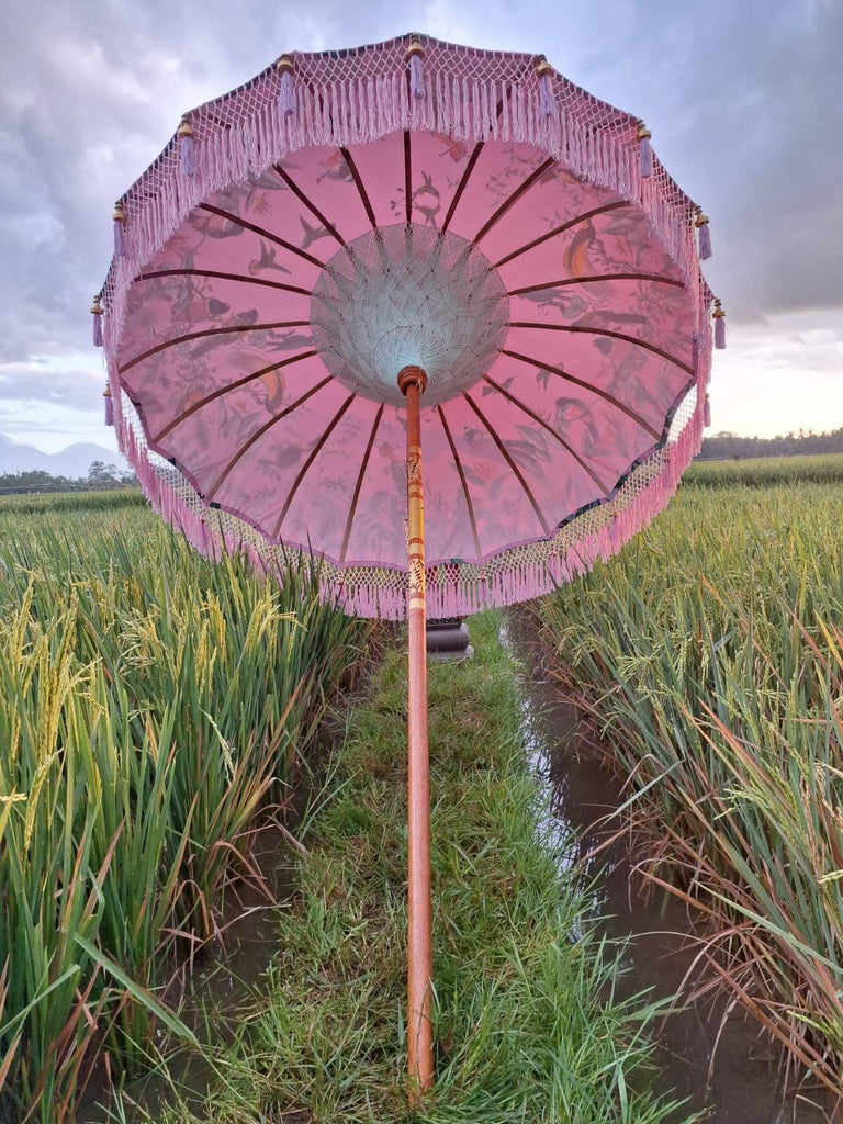 Underside view of the Birdie Parasol showcasing white taffeta lining and bamboo spokes for sturdy support.