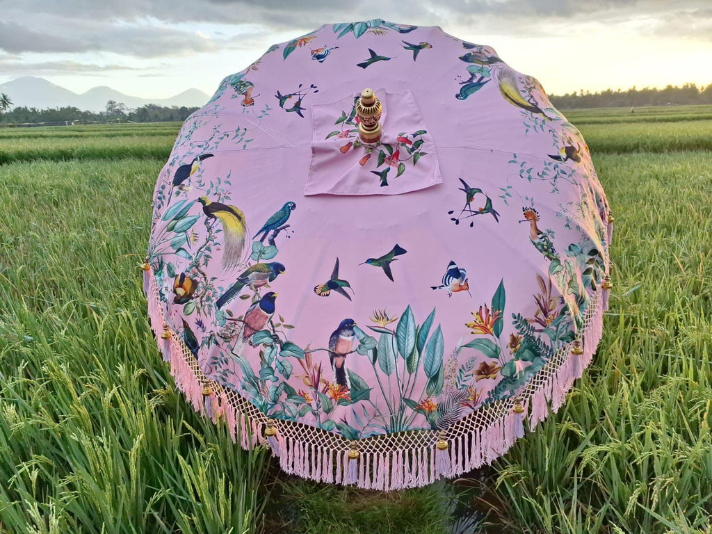 Detailed view of exotic birds and lush greenery on the Birdie Parasol, combining nature and elegance.