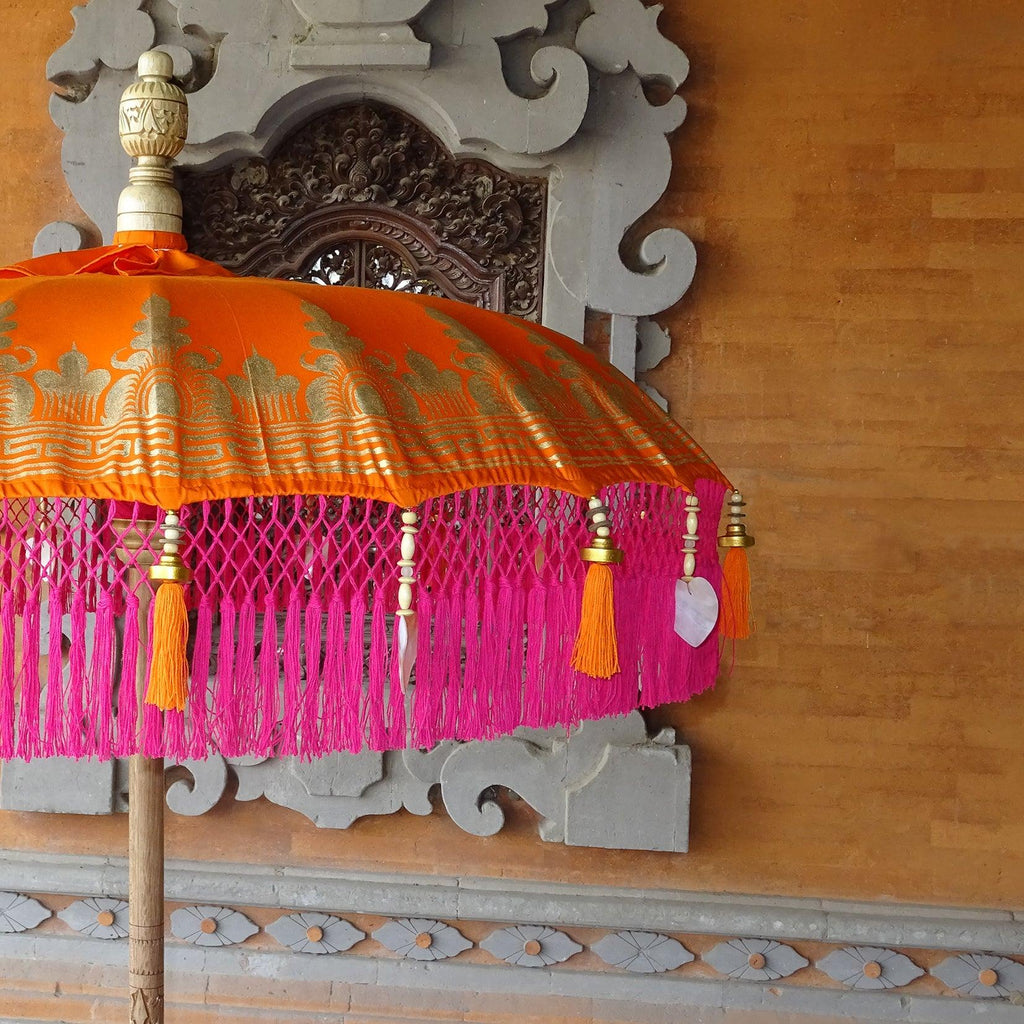 Close-up of the Clementine Parasol’s fringe with pink tassels and delicate heart-shaped seashells.