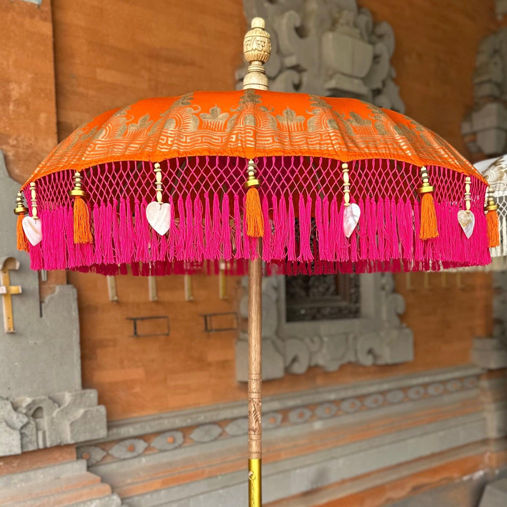 Close-up of the Clementine Parasol’s fringe with pink tassels and delicate heart-shaped seashells.