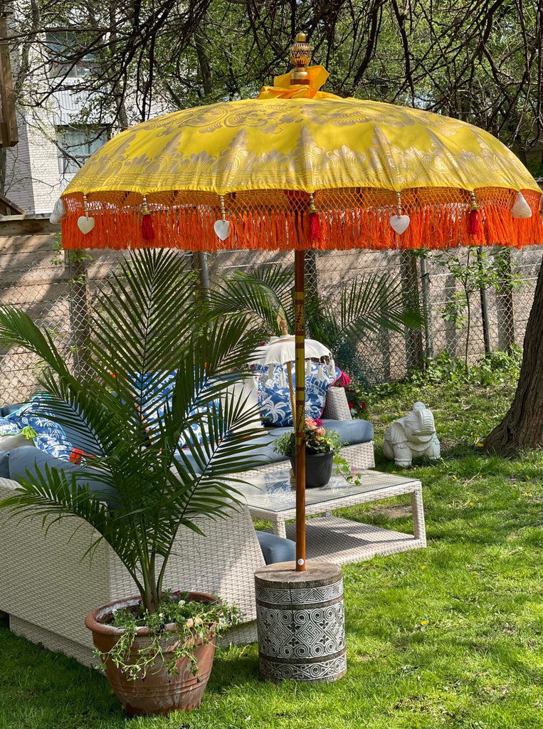 Detailed gold artwork on the Arabella Parasol, showcasing intricate craftsmanship on yellow fabric.