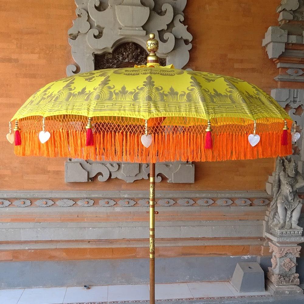 Detailed gold artwork on the Arabella Parasol, showcasing intricate craftsmanship on yellow fabric.