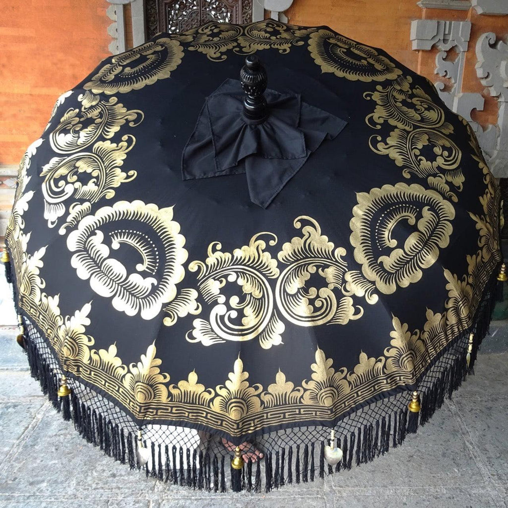 Carl Parasol with bold black canvas and intricate gold ink designs, perfect for luxurious outdoor spaces.