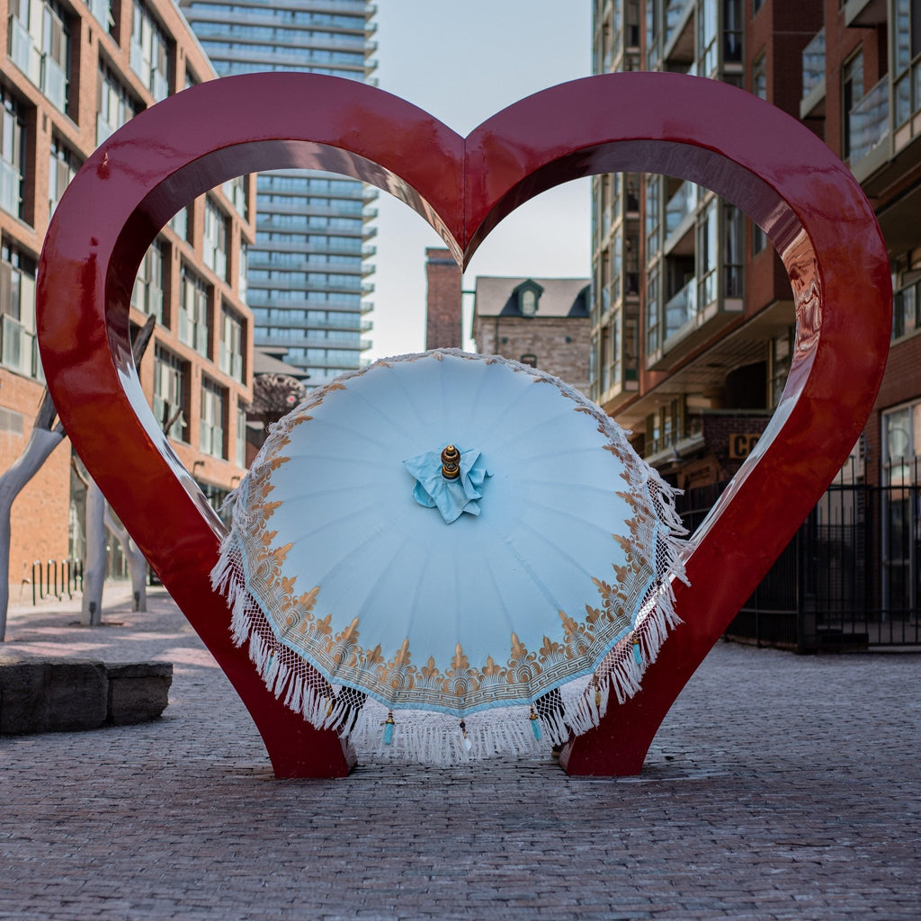 Baby Blue Parasol with gold hand-painted details and light blue tassels, perfect for elegant outdoor spaces.
