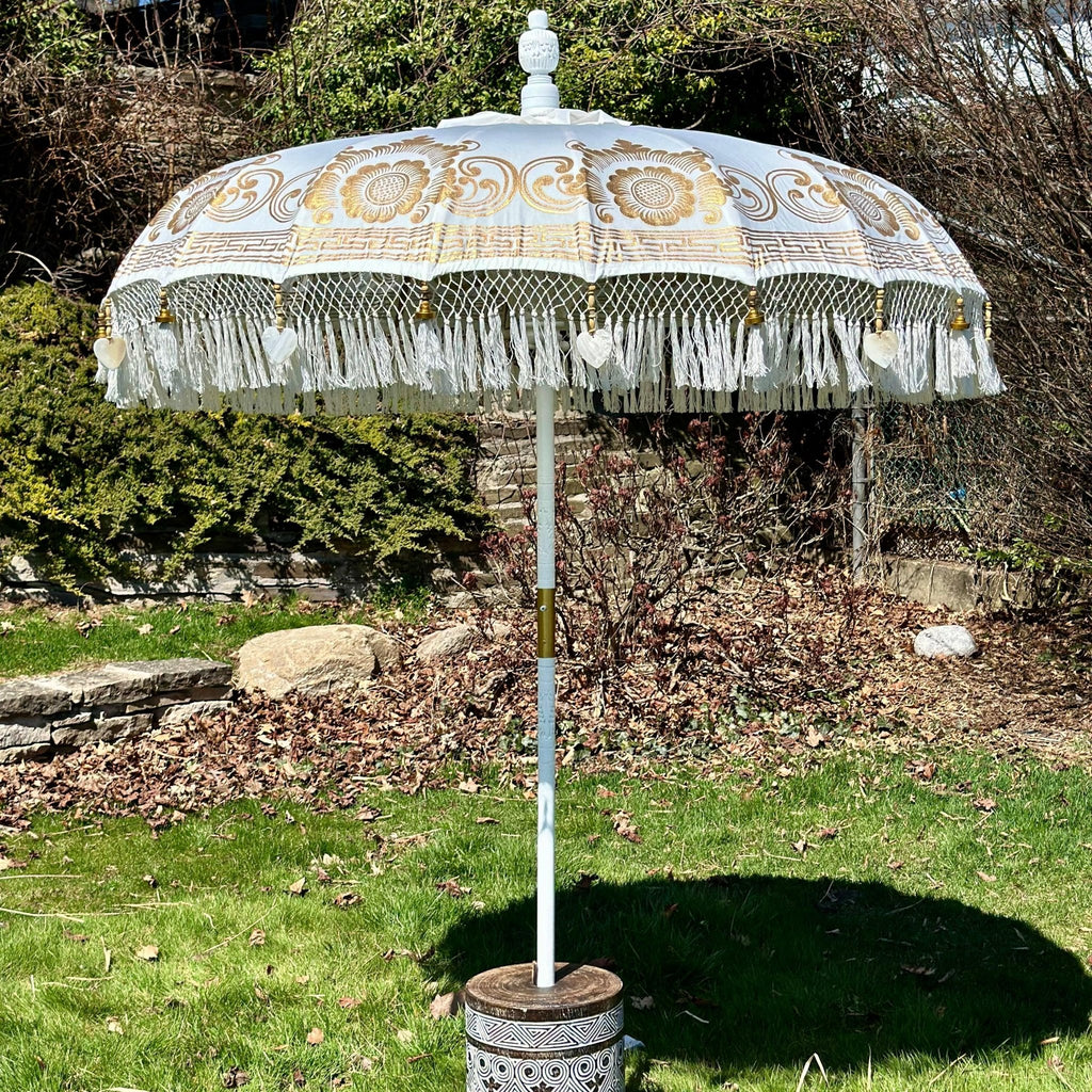 Elegant Ally Parasol with white canvas, gold accents, and a carved wooden pole—ideal for gardens and terraces.